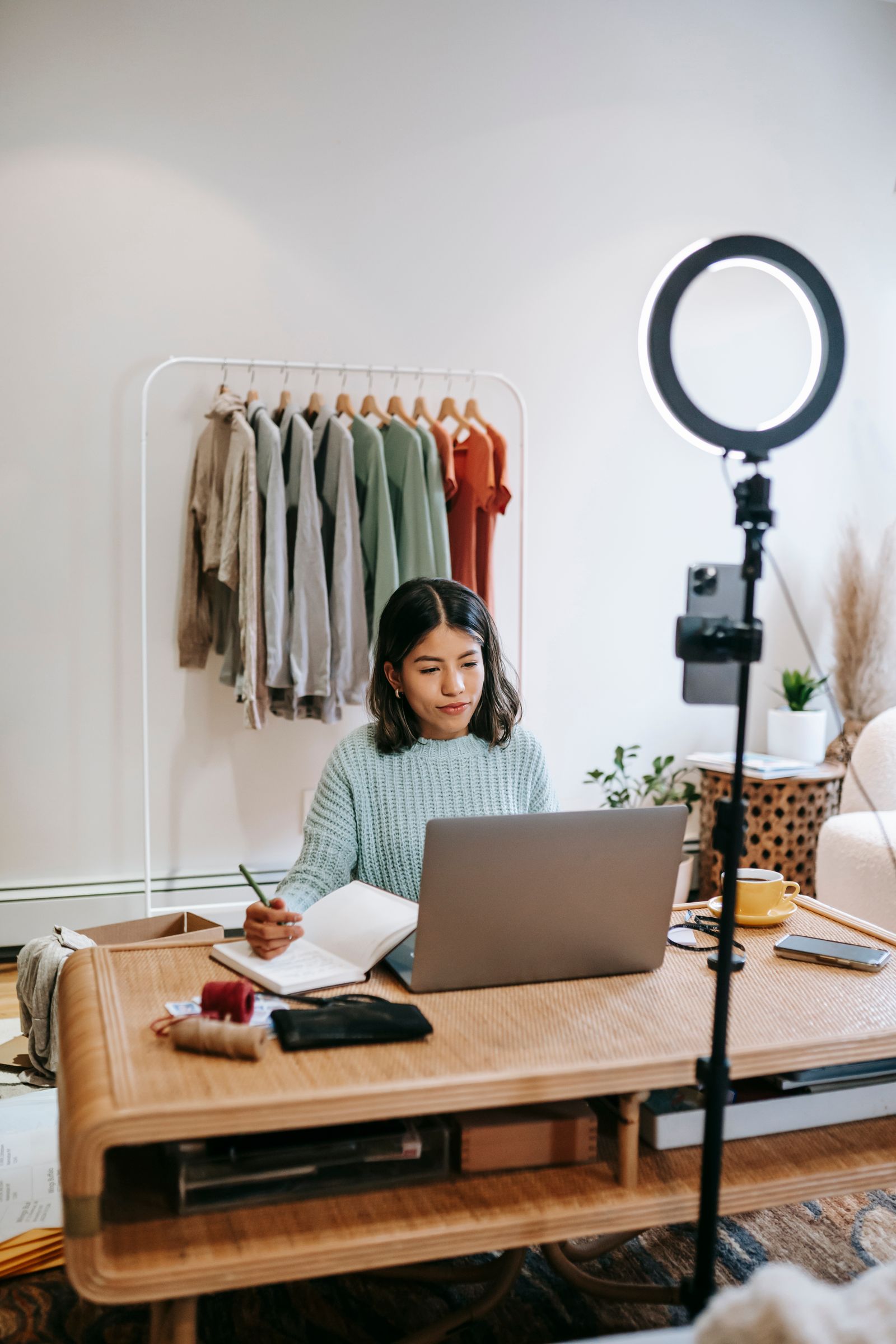 Influencer working at a desk with a ring light and laptop