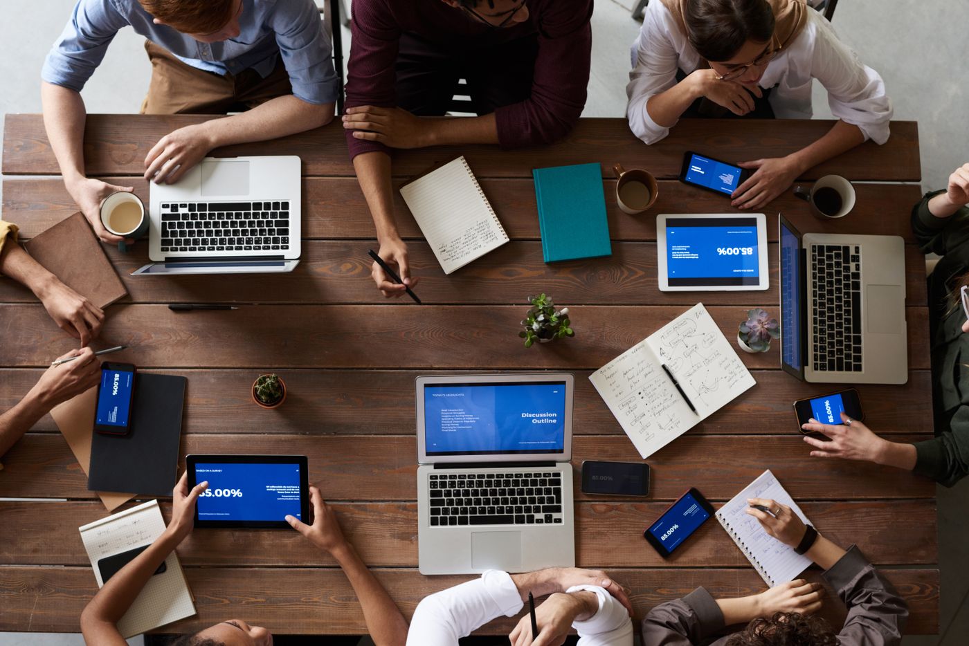 Team working on laptops around a shared table