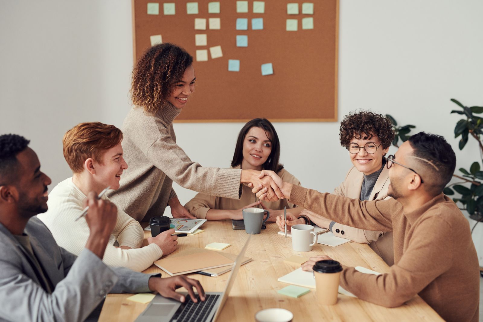 Colleagues working together around a laptop