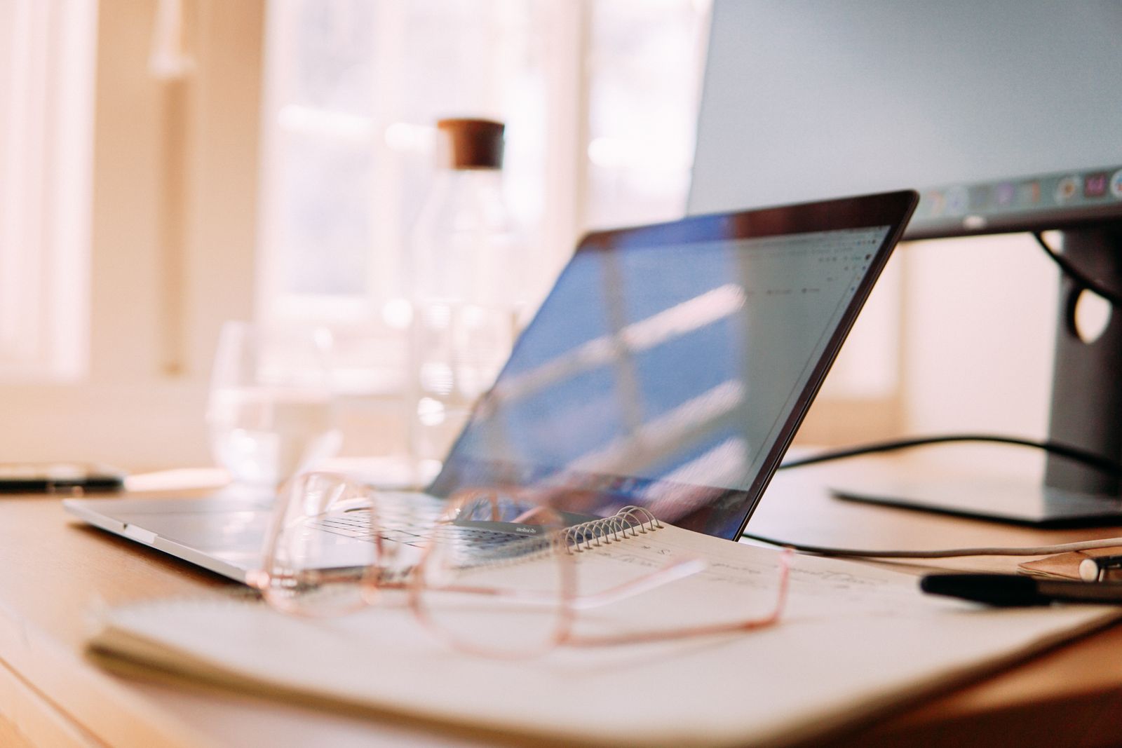 Laptop open on a wooden desk