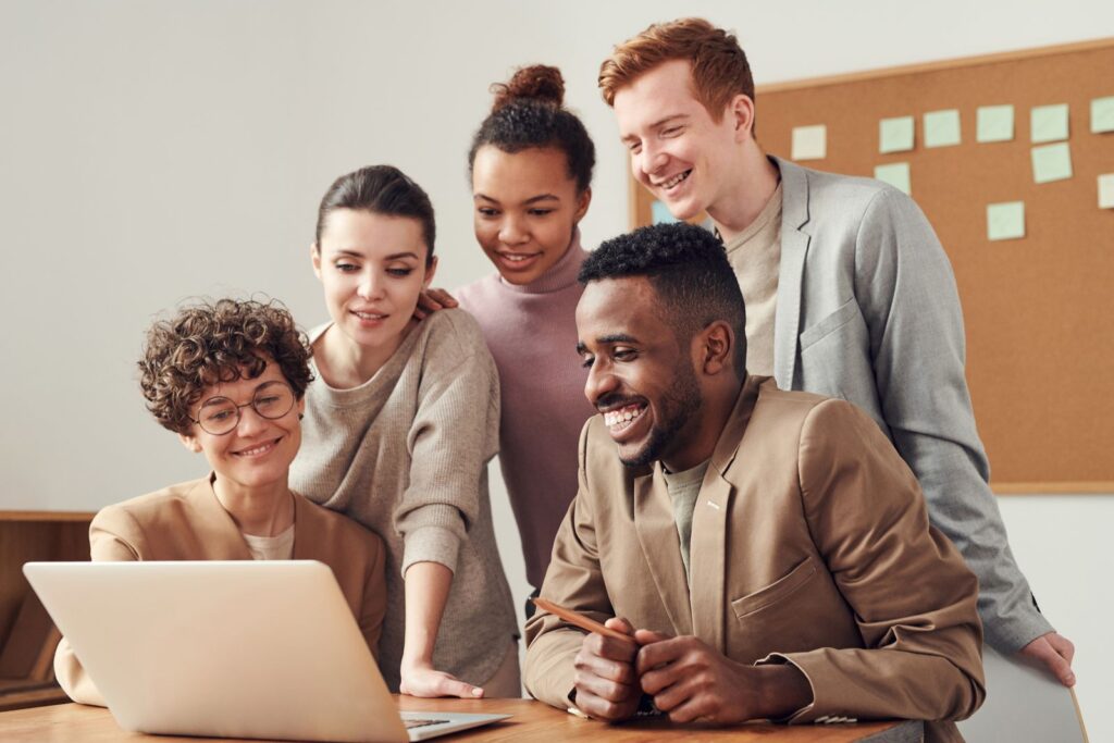 Colleagues looking at a laptop together